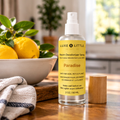 Paradise room spray in a bright kitchen with lemons