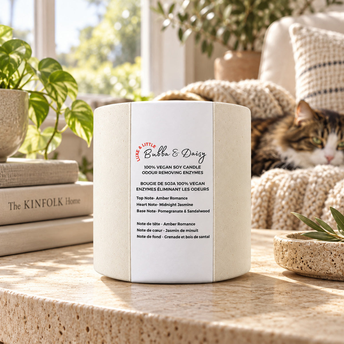 Luxe & Little Bubba and Daisy vegan soy candle in a neutral, gender-inclusive setting: cozy luxe candle with cat and greenery