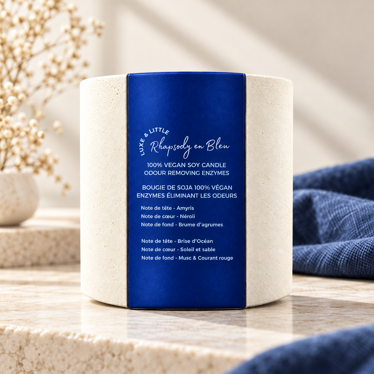 Rhapsody en Bleu candle styled on pale stone with navy linen